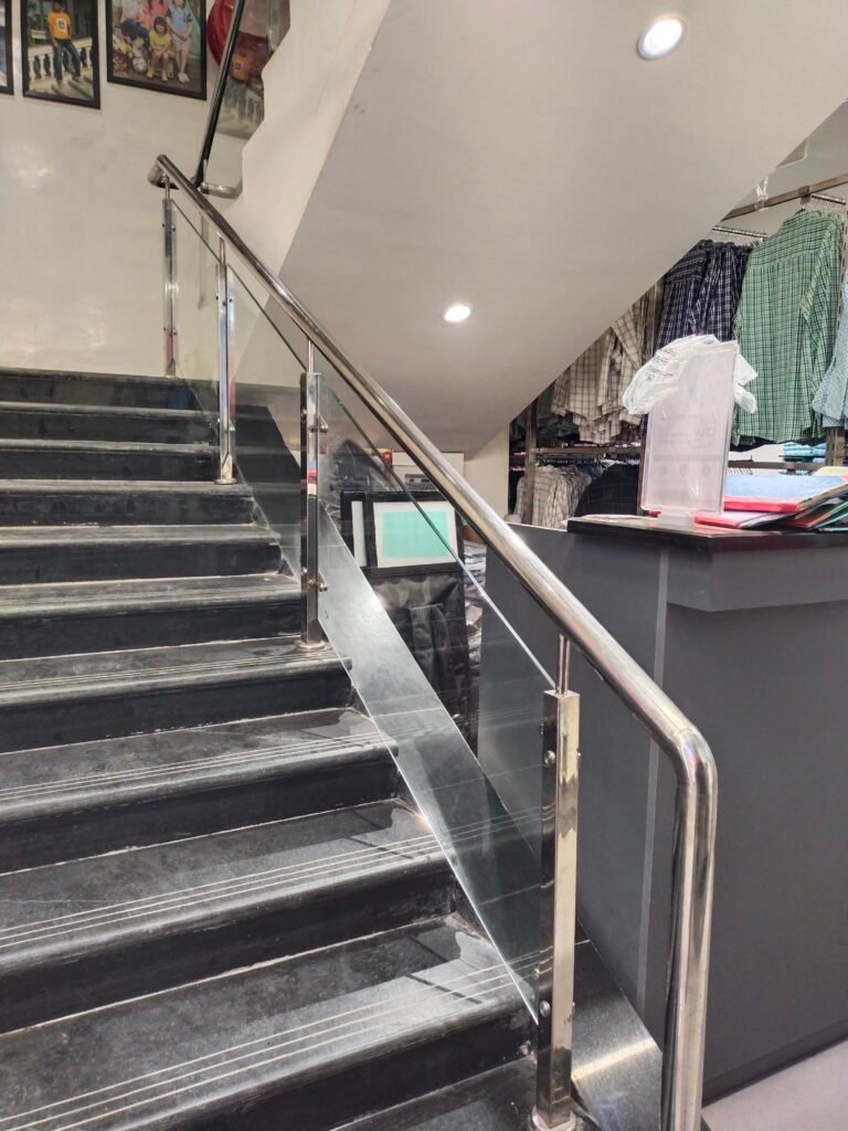 Modern glass railing with stainless steel fittings for balcony and staircase