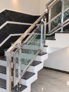 Modern stainless steel and glass staircase railing designed by Aryan Steel Art